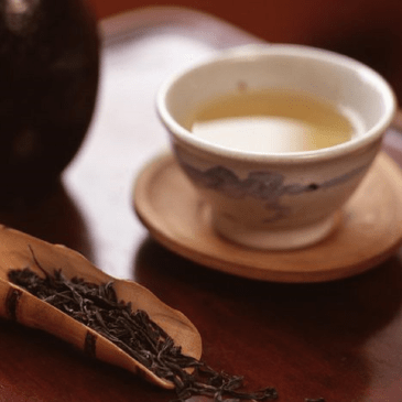 Korean tea in white cup on wooden table